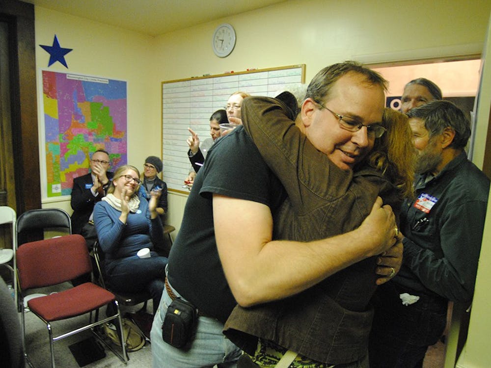 Democratic candidate Eric Schmitz, embraces his wife after his victory for Monroe County Recorder is announced. Schmitz, along with other local democrats, addressed the Monroe County watch party Tuesday night. 