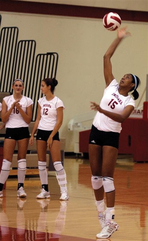 Junior outside hitter Erica Short spikes the ball as teammates senior Gabrielle Allison (left) and senior Annie Moddrell look on during the Hoosiers' game against Northwestern on Aug. 9 at the University Gym. The Hoosiers' won the game with a final score of 3-1.