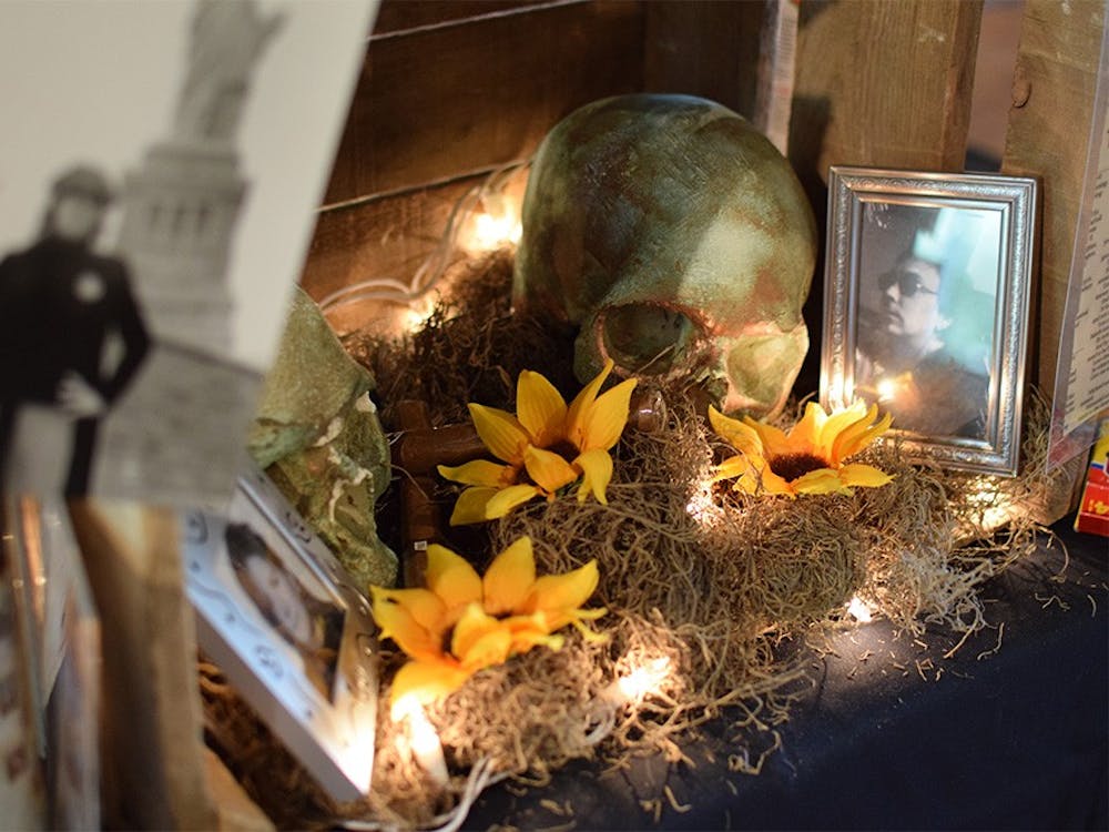 The Día de los Muertos Community Altar at the Mathers Museum of World Cultures consists of collections of photos, notes and decorations to honor the dead. Curators of the altar Rachel DiGregorio and Michael Redman organize and construct the altar each year, which was originally housed in Wandering Turtle Art Gallery.