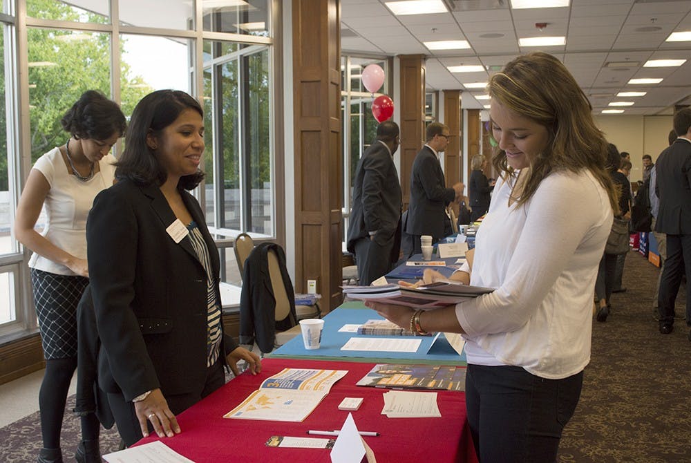 Senior Caitlin Gardner fills out paperwork for information on the School of Law at Northeastern University at the IU Law School Fair on Monday in Alumni Hall.