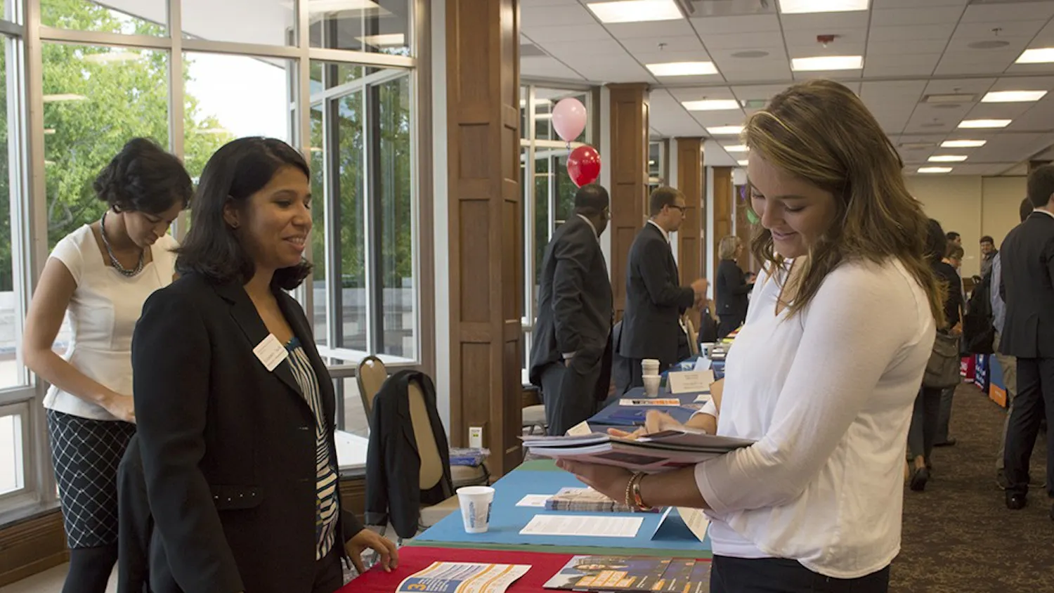 Senior Caitlin Gardner fills out paperwork for information on the School of Law at Northeastern University at the IU Law School Fair on Monday in Alumni Hall.