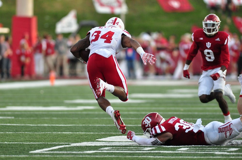 Junior Chase Dutra trips up Nebraska's Terrell Newby at Memorial Stadium on Saturday. IU lost 27-22.