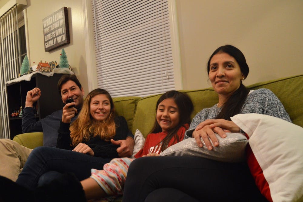 <p>The Carmona family tries to settle on a television show in their living room in Bloomington. More than two years after fleeing violence in Venezuela, they await a decision over whether they will be granted asylum in the United States.</p>