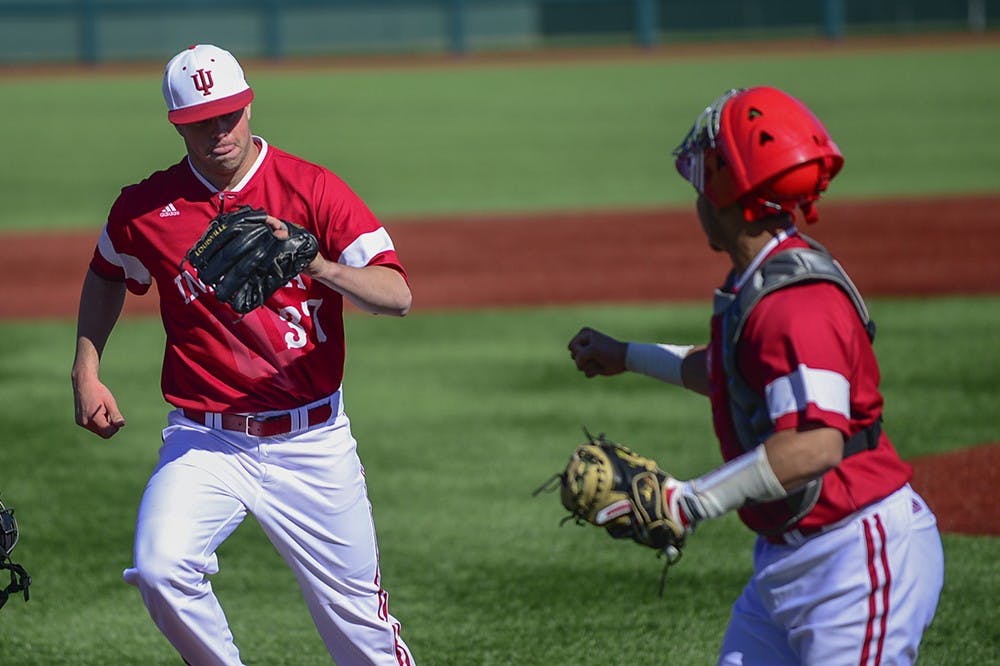 Junior Scott Effross celebrates with freshman catcher Demetruis Webb after pitching in the first inning of IU's game against Valparaiso on Mar. 17 at Bart Kaufman Field.