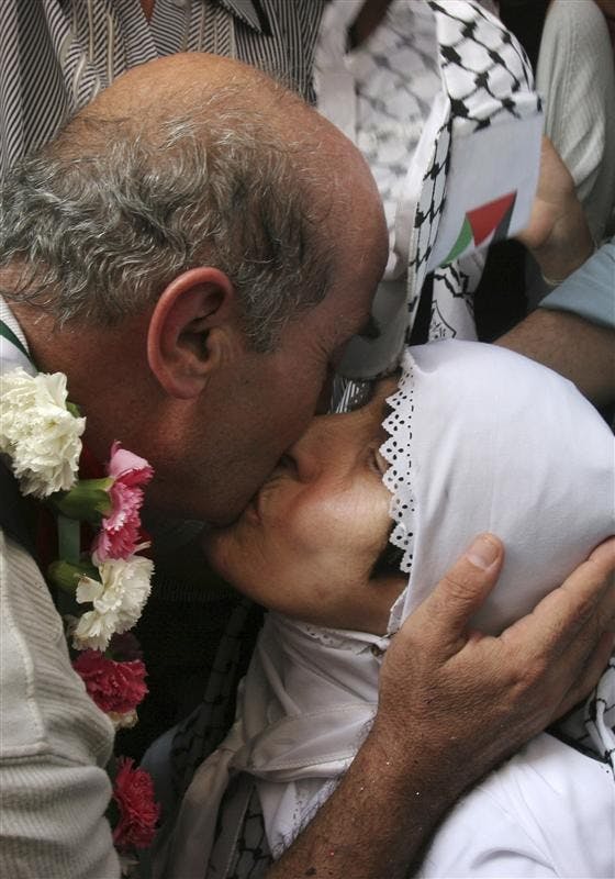 Released Palestinian prisoner Said al-Atba, 57, kisses his mother as he arrives Monday in the city of Nablus. Al-Atba was the longest serving Palestinian inmate in Israel, having served 31 years of a life sentence for masterminding a 1977 market bombing that killed one 
and wounded dozens more in central Israel.  