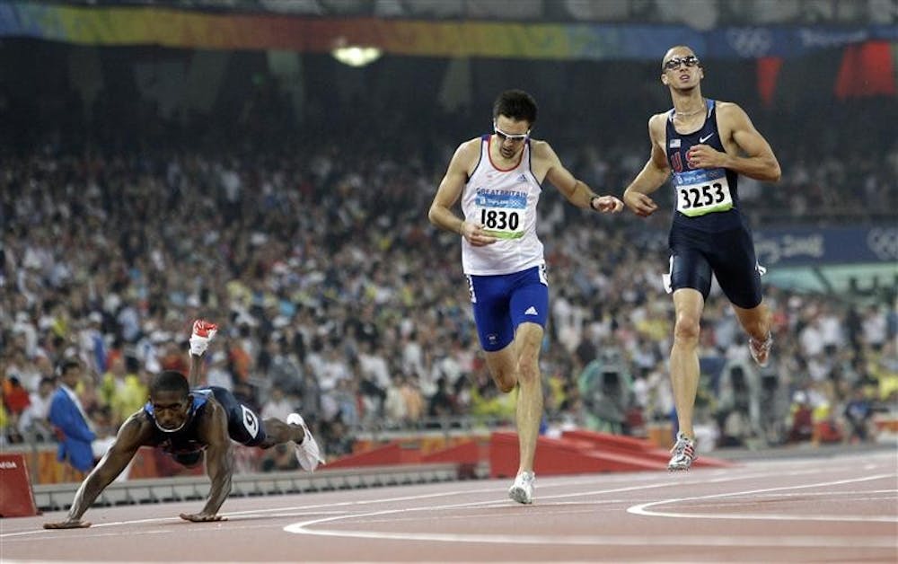 United States' David Neville, Britain's Martyn Rooney and United States' Jeremy Wariner, from left, cross the finish line of the men's 400-meter final during the athletics competitions Thursday in the National Stadium at the Beijing 2008 Olympics in Beijing
