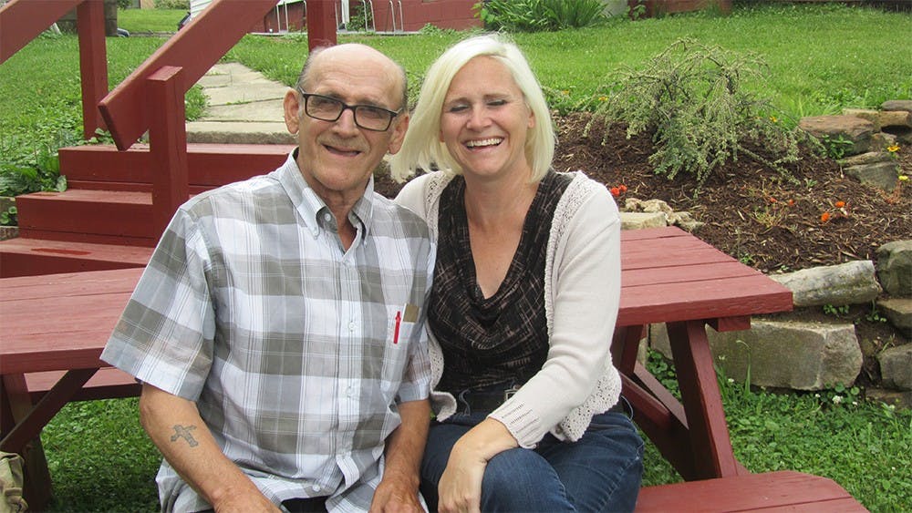 Elaine Guinn sits outside of New Hope Family shelter, where she is the Executive Director, with her father, Logan Guinn. 