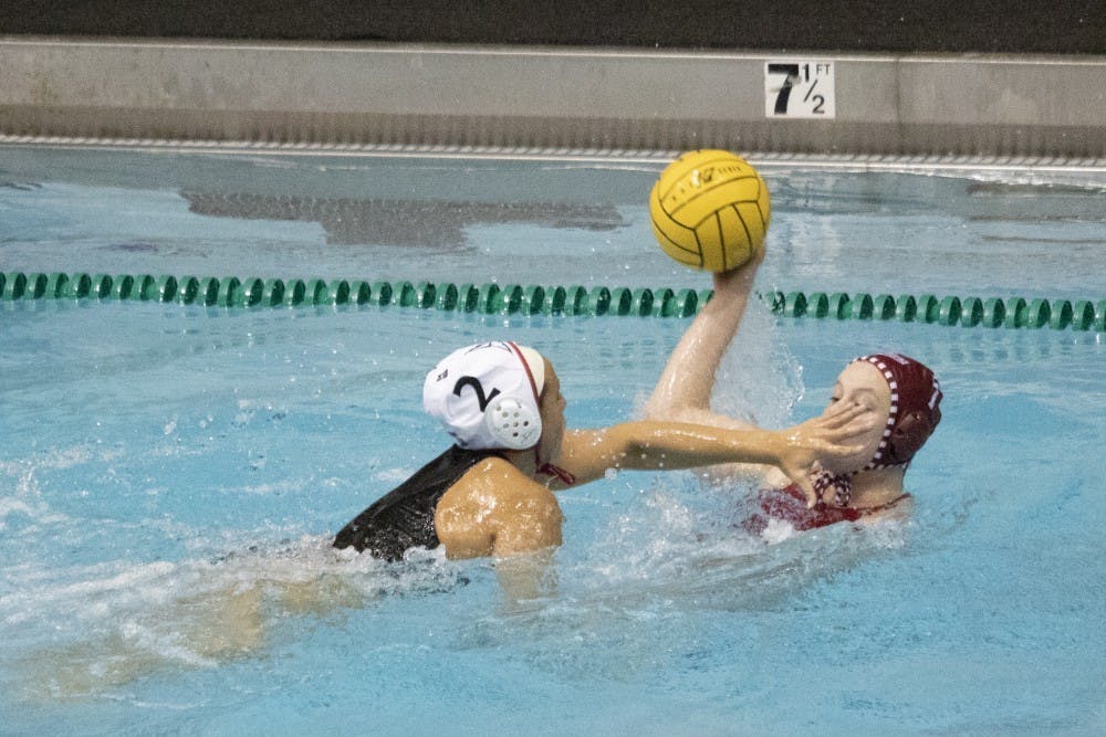 <p>California State University junior utility Jennalyn Barthels blocks junior driver Emily Powell’s face March 3, 2019, in Counsilman Billingsley Aquatics Center. The team had three consecutive wins in its home opener this weekend. </p>