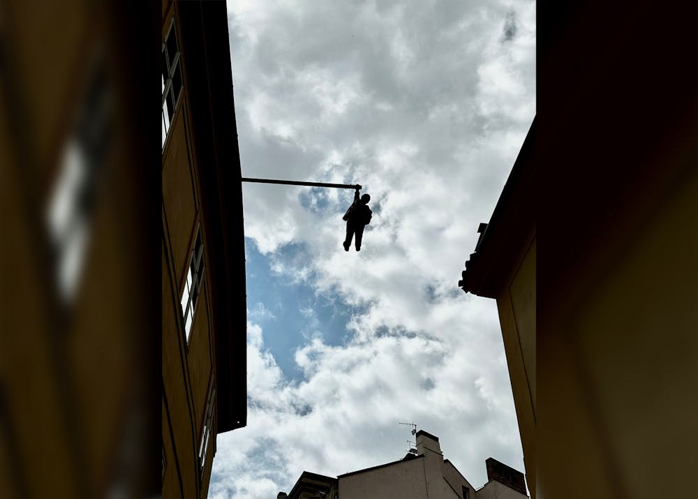 <p>&quot;A Man Hanging Out&quot; is photographed May 14, 2023, in Prague, Czech Republic. The statue depicts Sigmund Freud hanging high above Old Town Prague. </p>