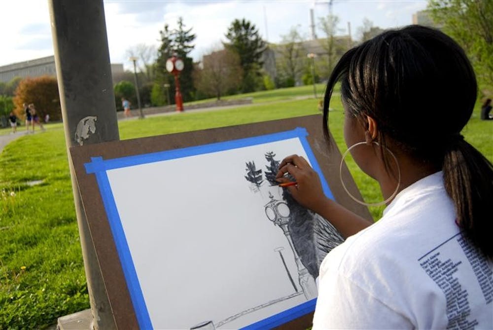 Sophomore Ciara Casey sketches at the Arboretum for her studio art class Monday afternoon. During dead week, students enjoy the outdoors to relieve stress before finals. 