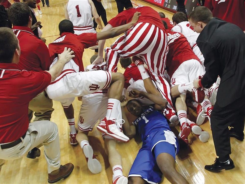 IU players storm the court and jump over Kentucky's Darius Miller (#1) and onto Christian Watford after he made the game winning basket against Kentucky on Dec. 10, 2011 at Assembly Hall. Kentucky was ranked #1 in the country. 