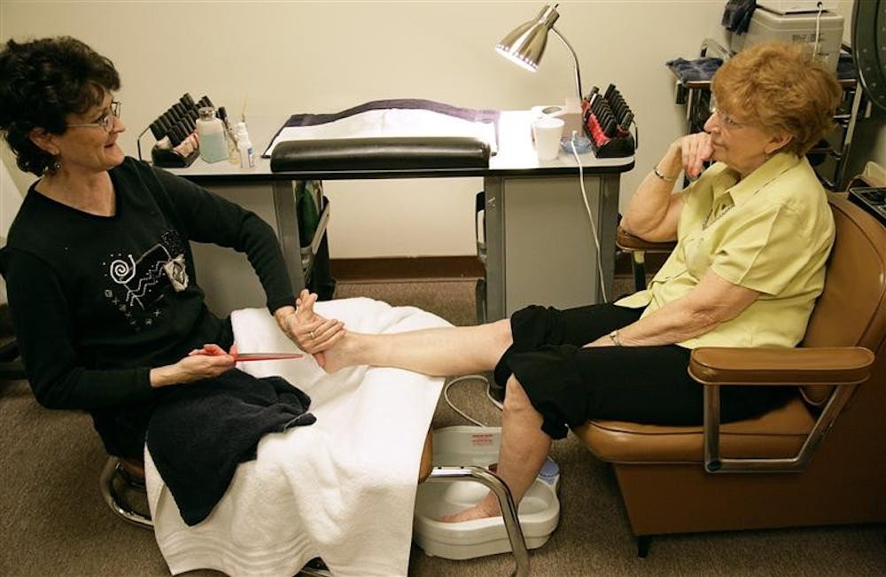 Deborah Deckard gives Bloomington resident Judy Clouers a pedicure Wednesday evening at the Macy’s Salon. Deckard toured in Iraq and Afghanistan and after recently returning from her second tour of duty, returned to work at the salon.