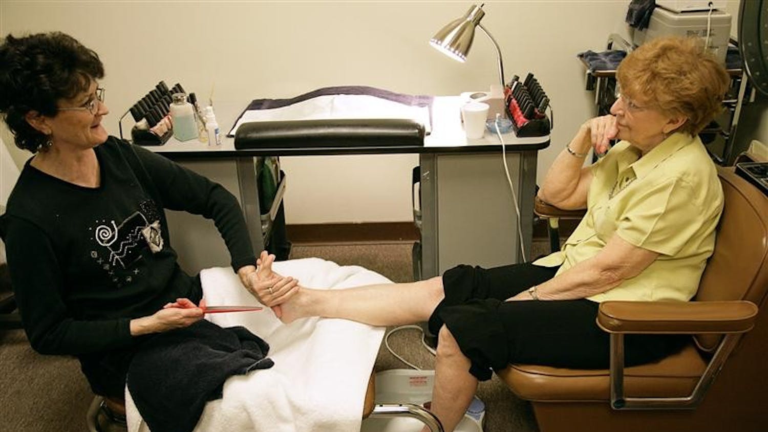 Deborah Deckard gives Bloomington resident Judy Clouers a pedicure Wednesday evening at the Macy’s Salon. Deckard toured in Iraq and Afghanistan and after recently returning from her second tour of duty, returned to work at the salon.