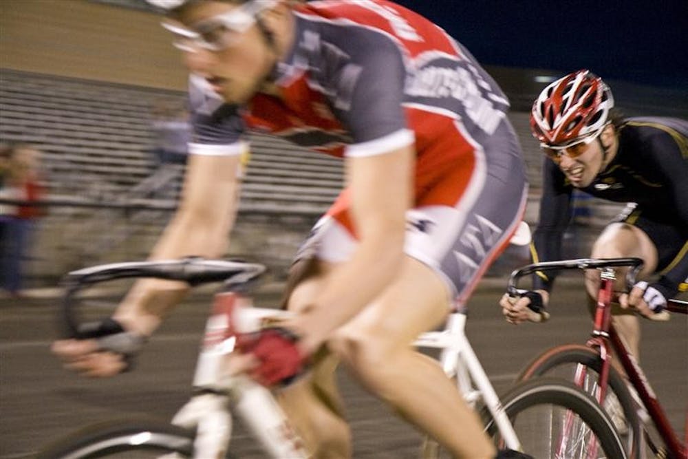 Eric Young of the Cutters passes Matt Neibler of Delta Tau Delta Wednesday evening at Individual Time Trials at the Bill Armstrong Stadium. Young, with a time of 2:18, had the fastest time of the evening.