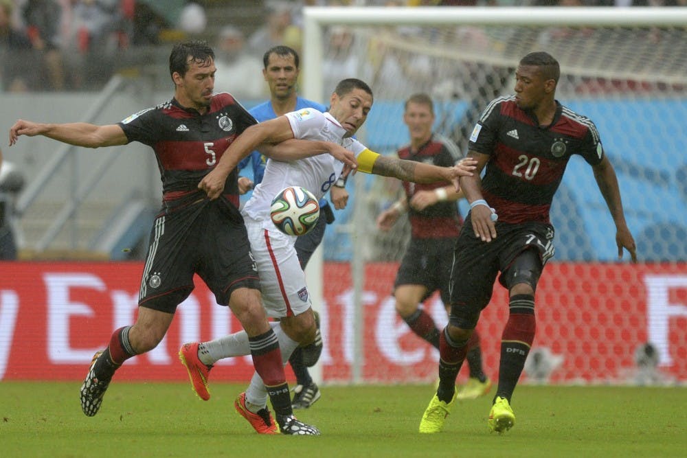 Clint Dempsey of Team USA, center, vies for the ball with Mats Hummels of Germany, left, and Jerome Boateng of Germany, right, during the FIFA World Cup at Arena Pernambuco in Recife, Brazil, on June 26, 2014.