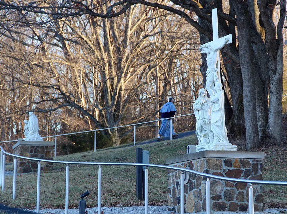 Father Elias Mary Millswalks the stations of the cross at the Mother of the Redeemer Retreat Center. Milswalks lives at the Mother of the Redeemer Retreat Center on Bloomington's west side, where he leads mass and various processionals around the property's prayer paths. The Mother of the Redeemer Retreat Center is considered "holy" ground on Bloomington's west side. 
