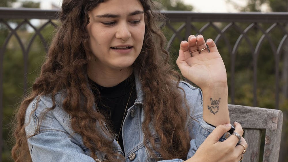 IU senior Katherine Brown shows her tattoo of the American Sign Language symbol for love Oct. 19 outside of Goodbody Hall. Brown said she might go fully deaf one day. 