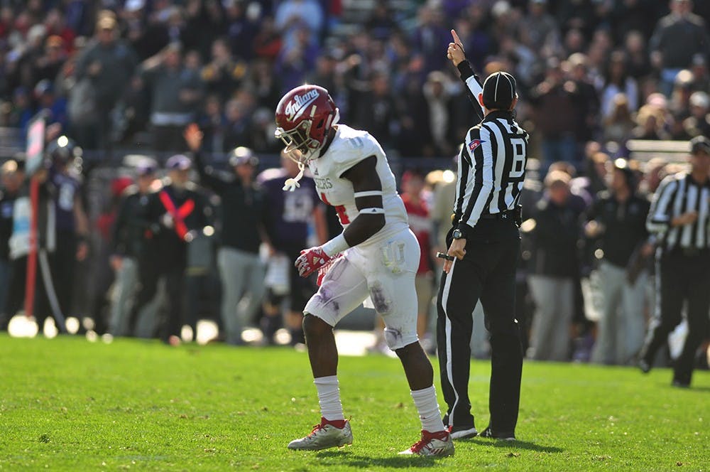 Senior wide receiver Ricky Jones walks off the field as a referee confirms a Northwestern interception. Indiana lost to Northwestern 24-14 on Saturday at Ryan Field in Evanston, Ill.