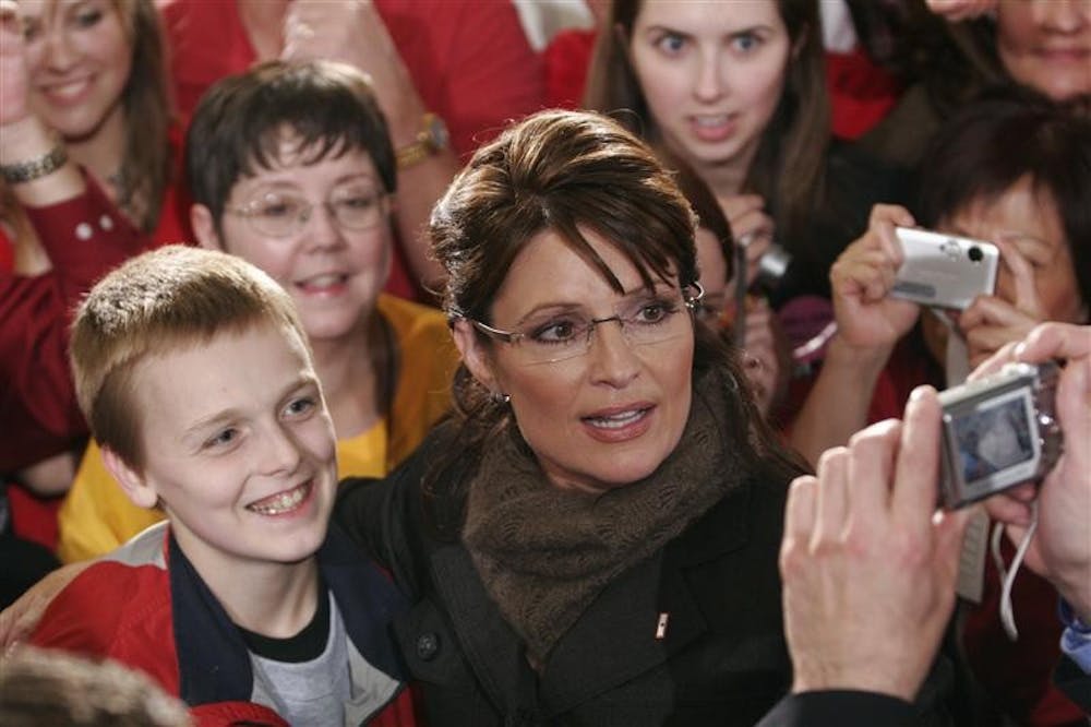 Republican vice-presidential candidate Sarah Palin poses for a photo with a supporter during a rally Wednesday in Jeffersonville.