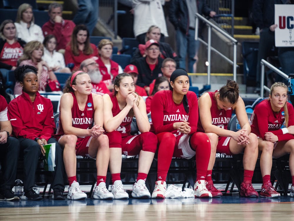 From left to right, Grace Berger, Mackenzie Holmes, Kiandra Browne, Ali Patberg, and Nicole Cardaño-Hillary sit on the bench as the final seconds run off the clock Mar. 26, 2022, at Total Mortgage Arena in Bridgeport, Conn. Indiana lost 75-58 against the University of Connecticut.