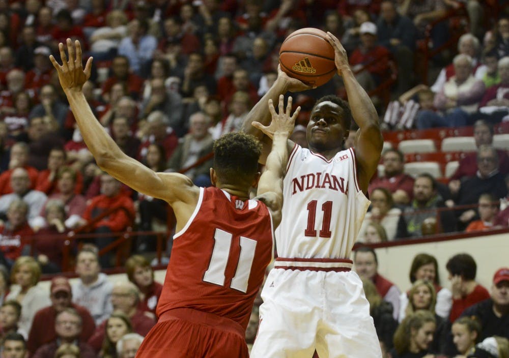 Senior guard Kevin "Yogi" Ferrell shoots a three while Wisconsin sophomore guard Jordan Hill defends on Jan. 5 at Assembly Hall. The Hoosiers won, 59-58.