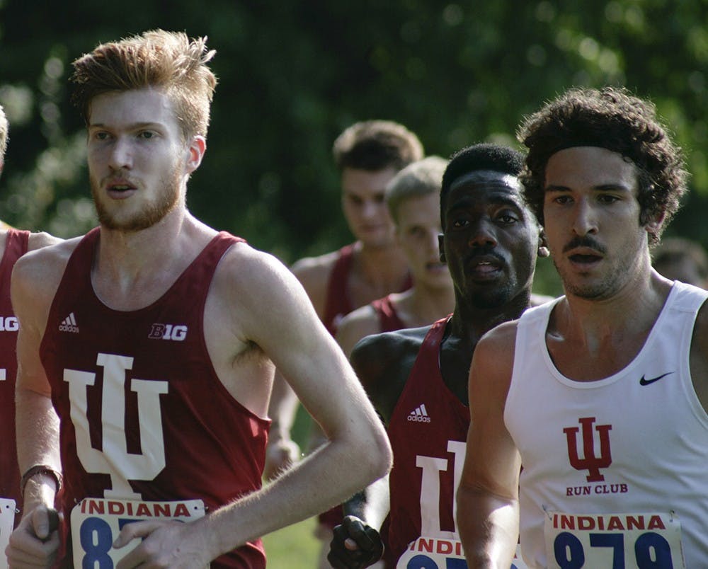 Carl Smith (left) runs as a part of the lead pack early in the Indiana Open on September 5. Both the men's and women's teams won by large margins and allowed the runners to compete for one of the first times this season.