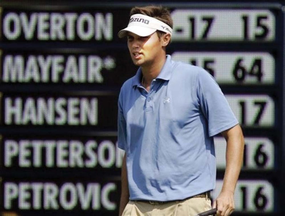 Jeff Overton tops the leader board as he looks at a putt on the 16th green during the third round of the PGA Tour's Wyndham Championship golf tournament in Greensboro, N.C., Saturday, Aug. 18, 2007. Overton leads the tournament and finished the day at 18-under-par 198. (AP Photo/Gerry Broome)