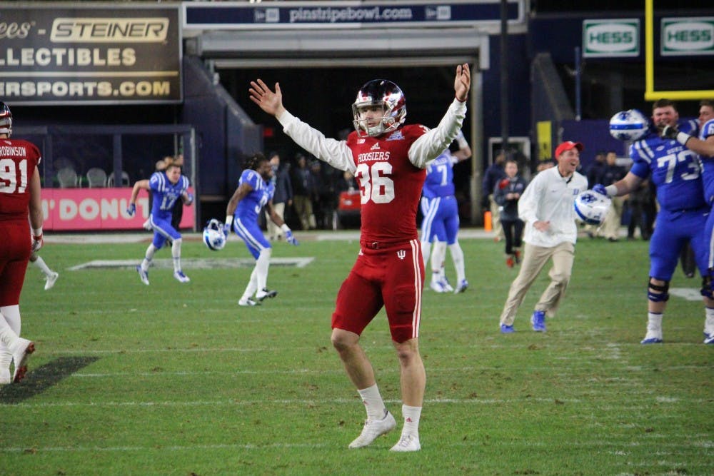 Punter Erich Toth raises his arms in disagreement&nbsp;with the referees' ruling that a field goal missed during the Pinstripe Bowl at Yankee Stadium on&nbsp;Dec. 26.&nbsp;