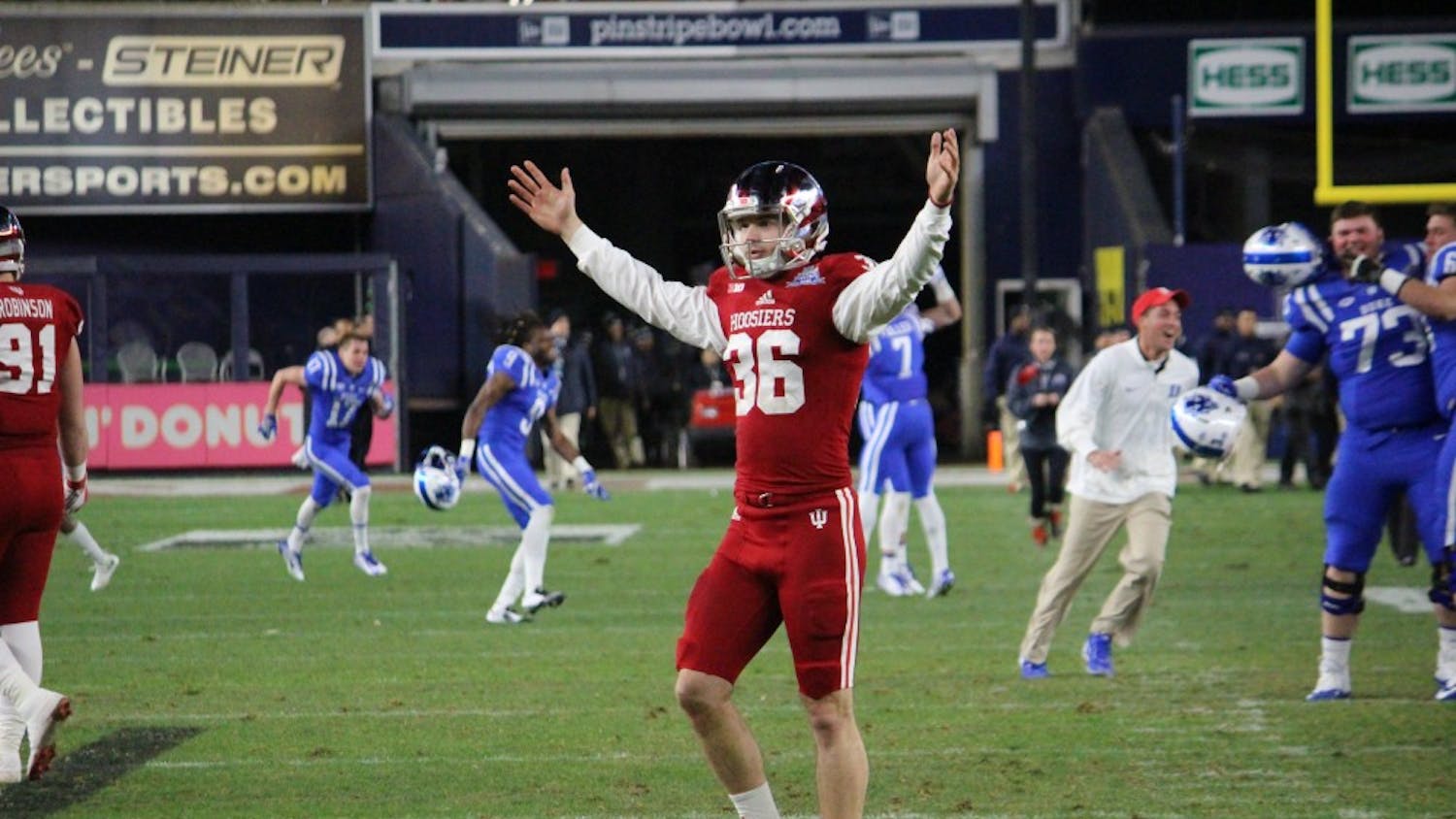 Punter Erich Toth raises his arms in disagreement&nbsp;with the referees' ruling that a field goal missed during the Pinstripe Bowl at Yankee Stadium on&nbsp;Dec. 26.&nbsp;