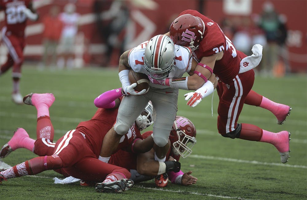 Linebacker Zeke Walker (6) and Oliver Marcus (44) and safety Chase Dutra (30) tackles Ohio State's Jalin Marshall (7) on Oct. 3 at Memorial Stadium. The Hoosiers lost to the number one ranked Buckeyes, 27-34.