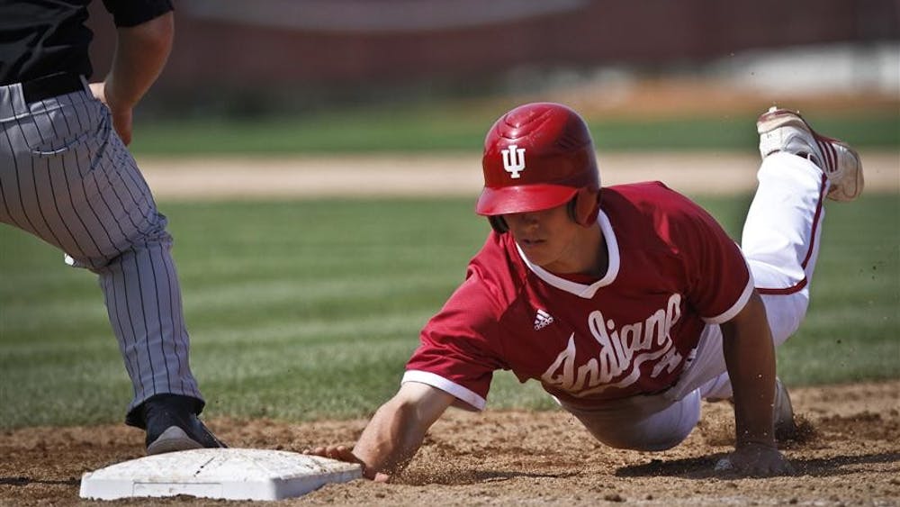 Freshman outfielder Chris Sujka dives into first after attempting to steal a base during IU's 10-5 win against Iowa on April 1 at Sembower Field. IU will play Georgia Southern this weekend in Bloomington.