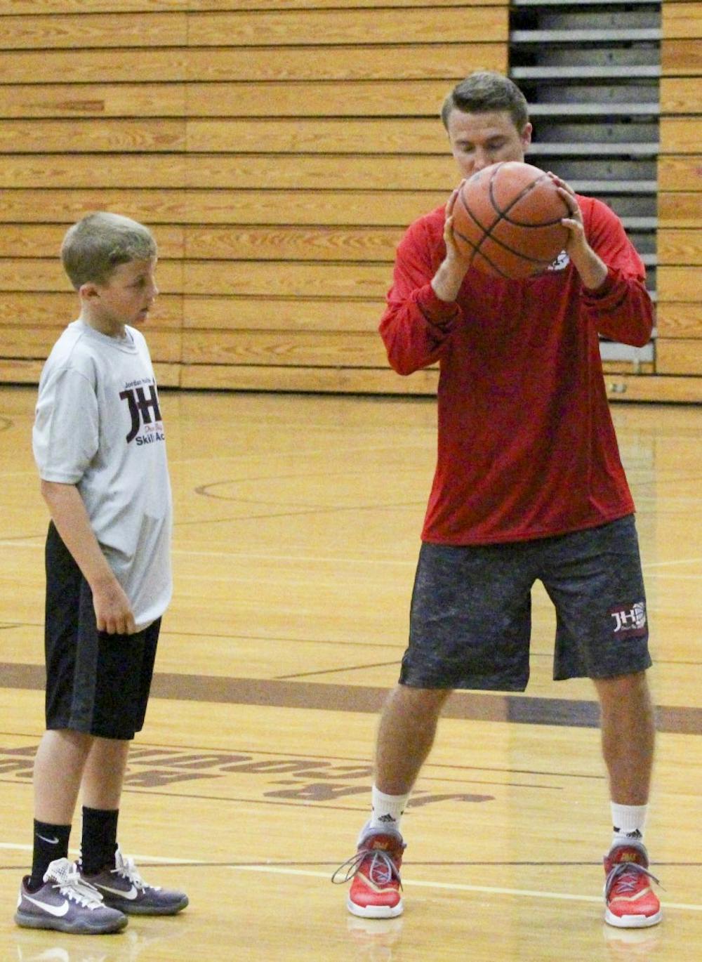 Jordan Hulls teaches students basketball skills Wednesday afternoon for his basketball camp at Bloomington South High School. “I want to teach theses kids the value of hard work,” Hulls said. 