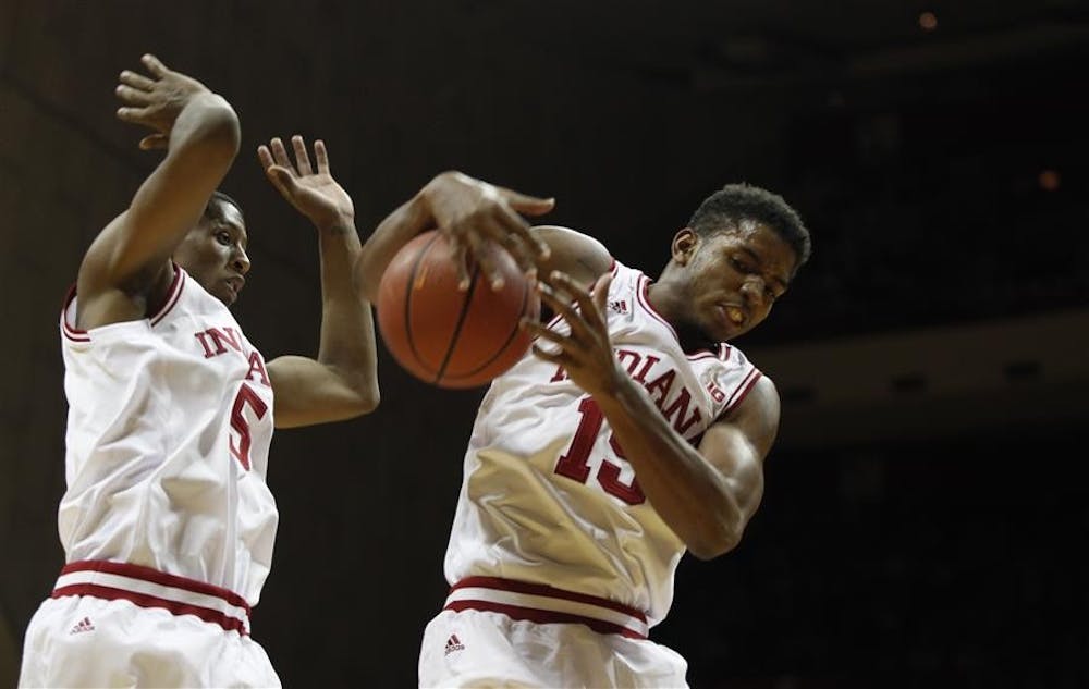 Troy Williams and Devin Davis secure the ball in the Hoosiers' season-opener against Chicago State on Friday at Assembly Hall. The Hoosiers won 100-72.