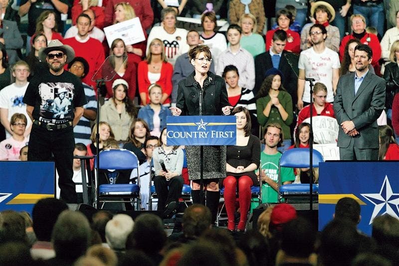 Republican vice-presidential candidate and Alaska Gov. Sarah Palin, flanked by country recording artist Hank Williams Jr. and husband Todd Palin, speaks to supporters during a campaign stop Saturday evening in Fort Wayne.