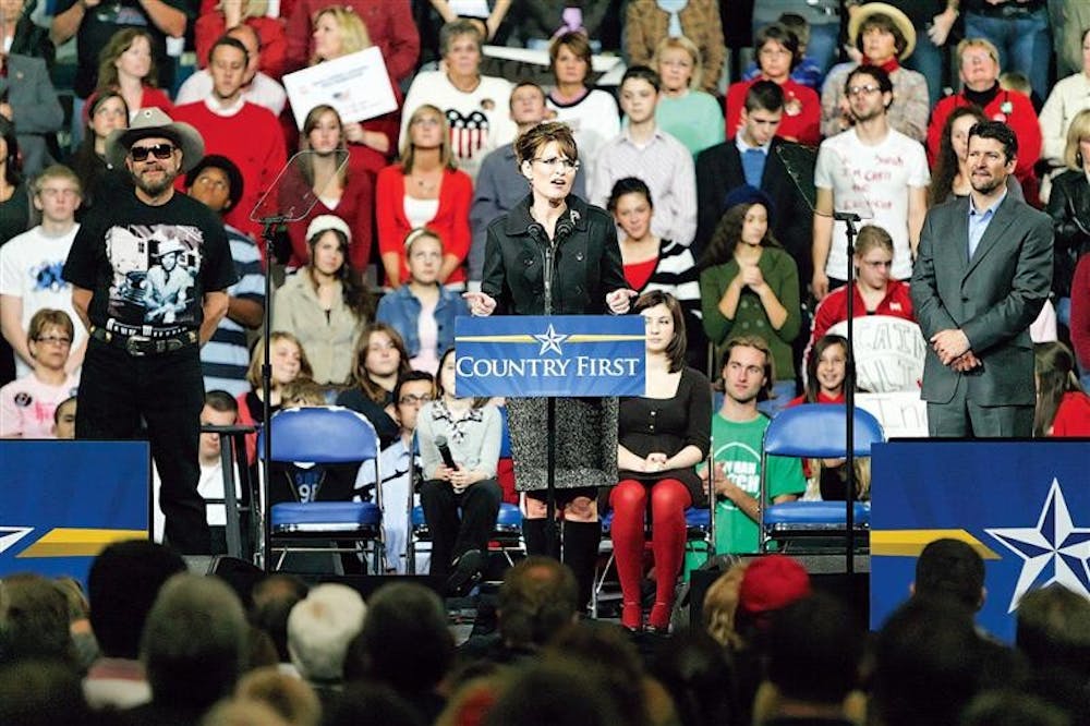 Republican vice-presidential candidate and Alaska Gov. Sarah Palin, flanked by country recording artist Hank Williams Jr. and husband Todd Palin, speaks to supporters during a campaign stop Saturday evening in Fort Wayne.