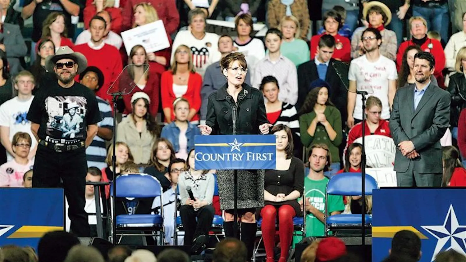 Republican vice-presidential candidate and Alaska Gov. Sarah Palin, flanked by country recording artist Hank Williams Jr. and husband Todd Palin, speaks to supporters during a campaign stop Saturday evening in Fort Wayne.