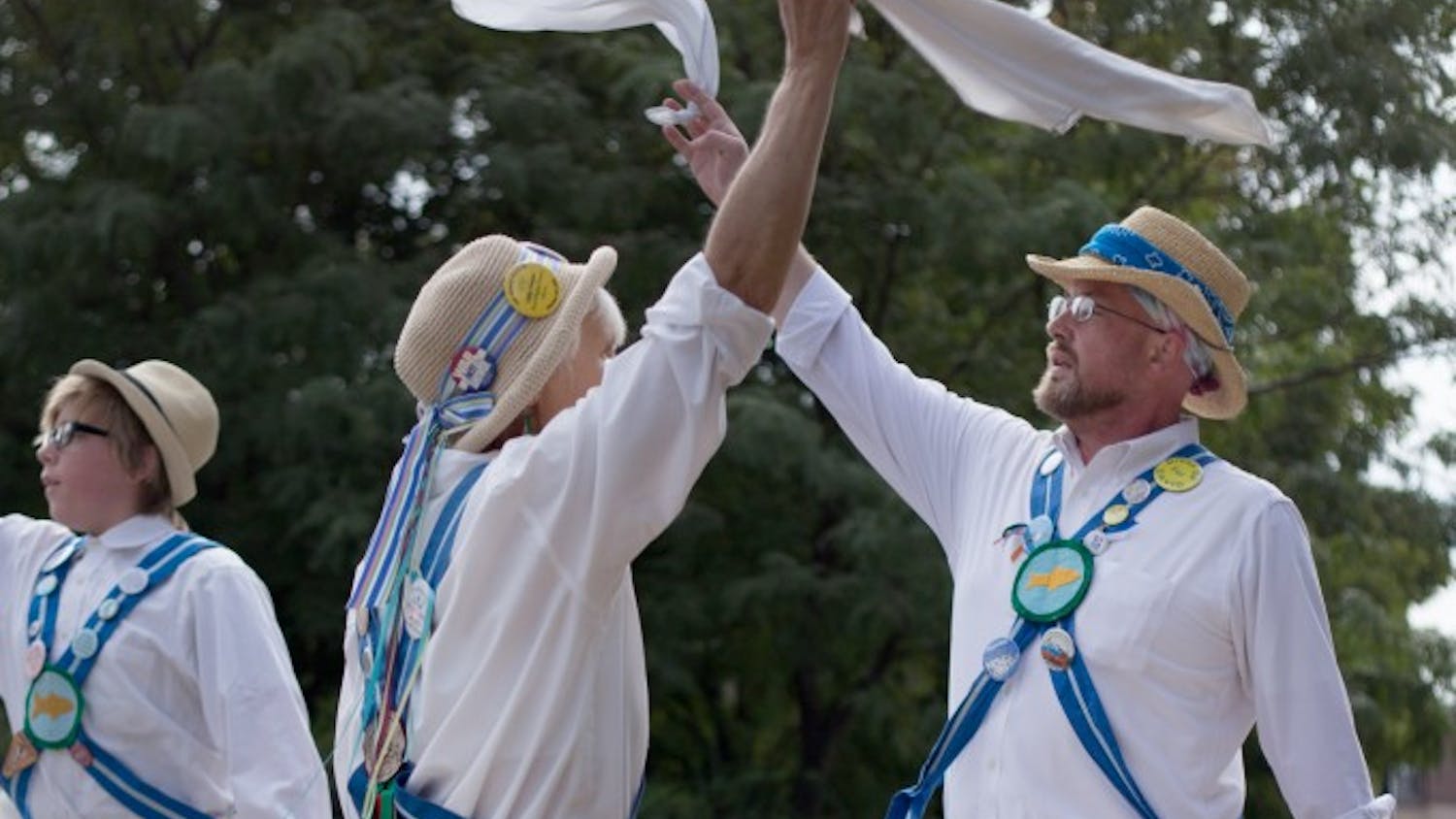 Martha Marmouze and Jeremy Nottinham perform Saturday at the Farmers Market in downtown Bloomington with their traditional English dance group, the Bloomington Quarry Morris. The group was founded more than 30 years ago and includes members from a variety of ages.