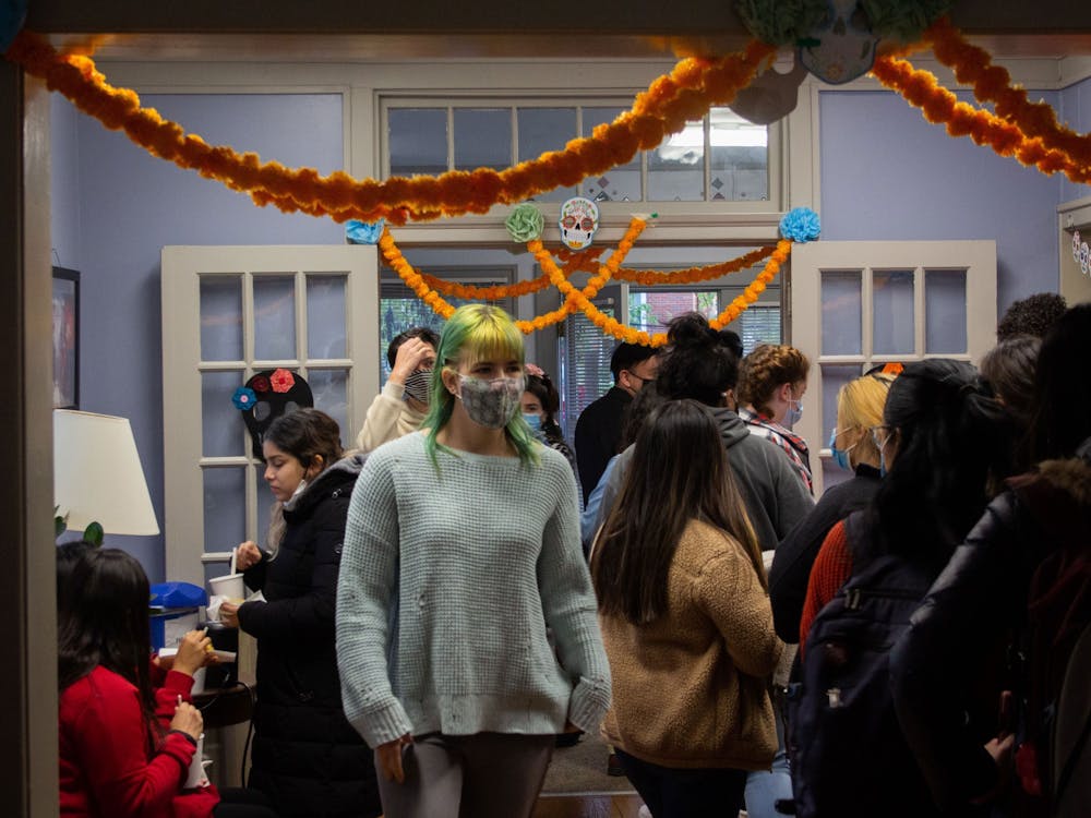 IU freshman Meredith Gray walks in a Día de los Muertos event on Nov. 2, 2021, at the La Casa Latino Culture Center. Students line up to enjoy the snacks provided at the event Tuesday.