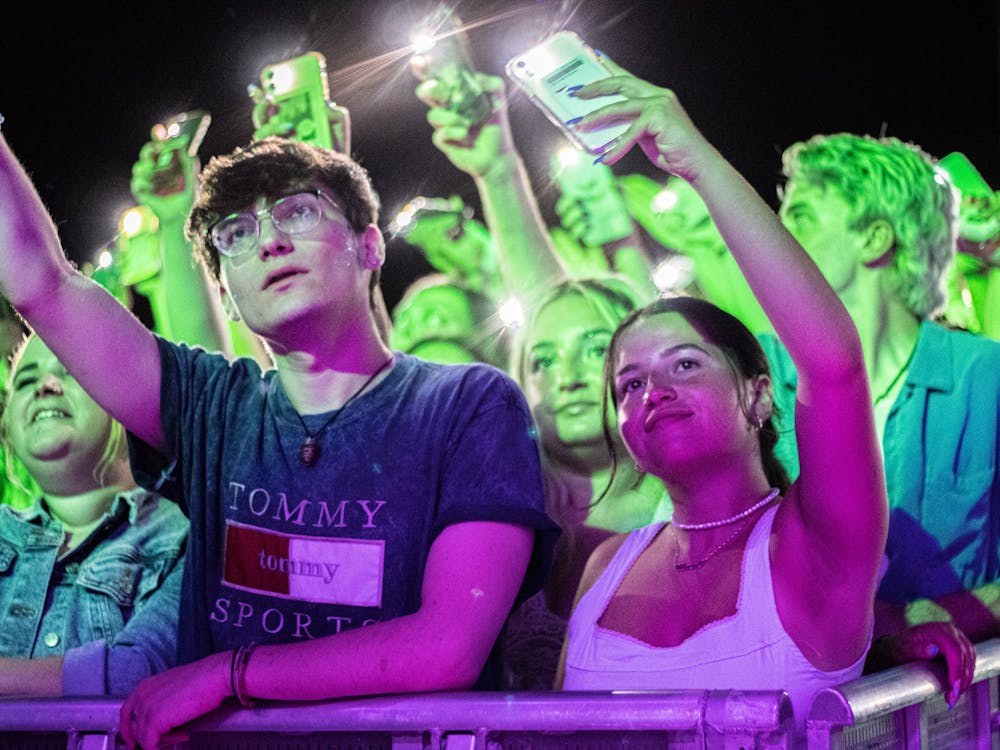 Concertgoers wave their cellphones to the music Saturday night during the Indiana Memorial Union Board Block Party. 