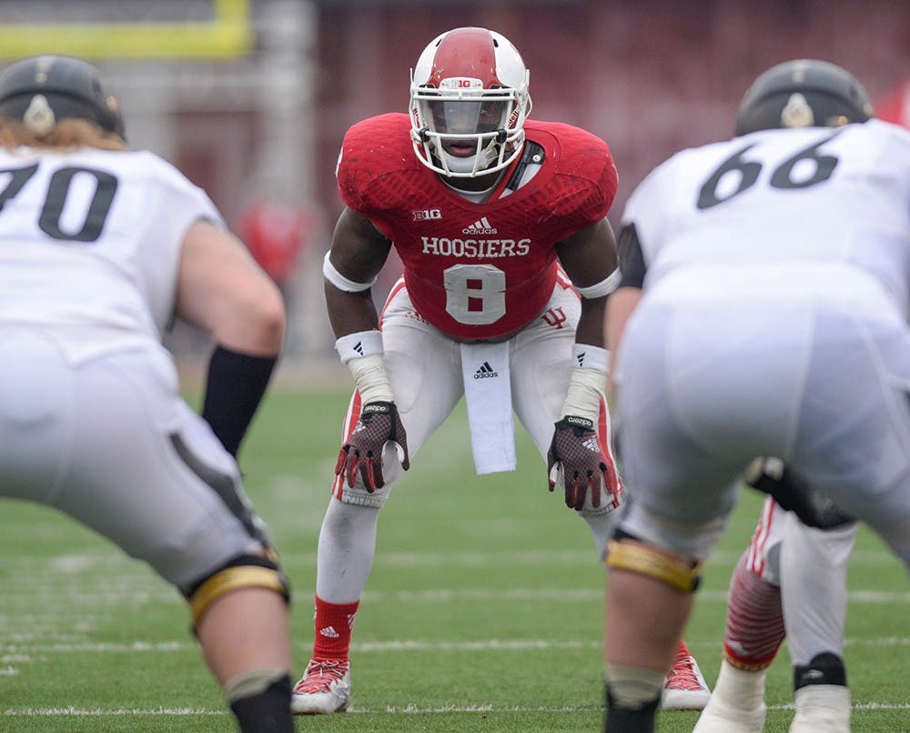 Freshman linebacker Tegray Scales anticipates the next play against Purdue on Saturday, Nov. 12, 2014 at Memorial Stadium. Scales was named to the Bednarik Award Watch List on Monday, an award given annually to the top defensive player in college football. 
