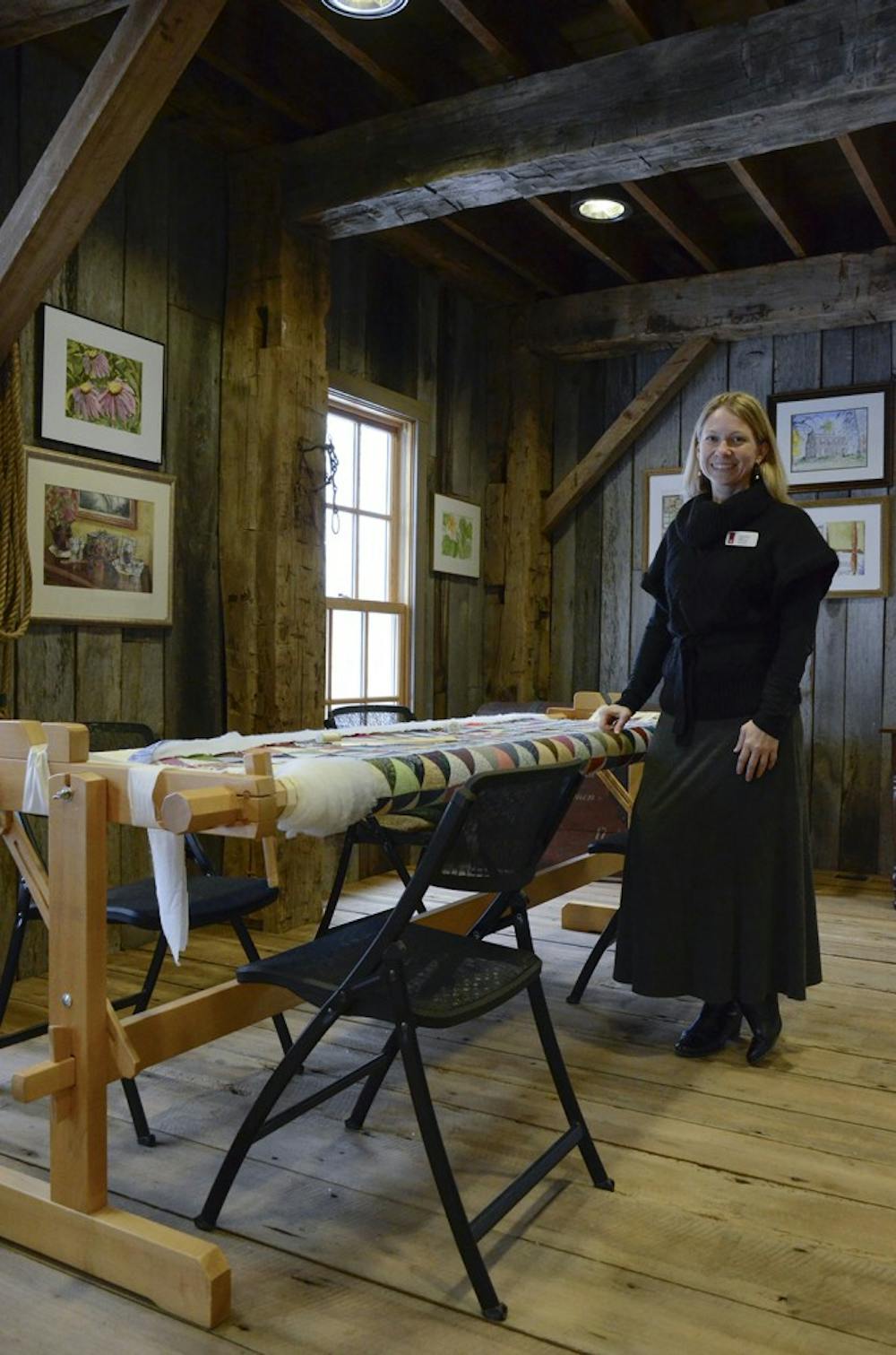 Carey Beam, Director of the Wylie House Museum, stands near a quilt machine in the Morton C. Bradley, Jr. Education Center. The Wylie House will be hosting the Bloomington Water Color Society's exhibit "We Paint... Heirlooms!" It will be on display through April at the Center (the barn next door to the Wylie House Museum). 