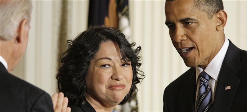 Vice president Joe Biden, left, and President Barack Obama, right, stand with Judge Sonia Sotomayor on Tuesday in the East Room of the White House in Washington. Obama announced her nomination to the Supreme Court.