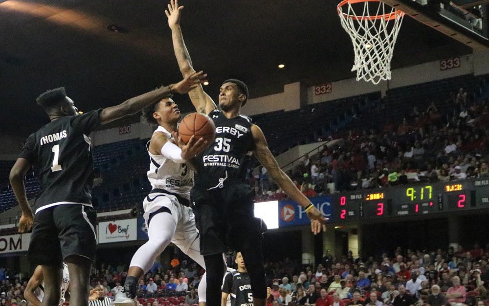 Justin Smith, a forward in IU's 2017 recruiting class, attempts a layup against two members of team Thunder during the Kentucky Derby&nbsp;Festival Basketball Classic on Saturday night in Louisville, Kentucky.&nbsp;