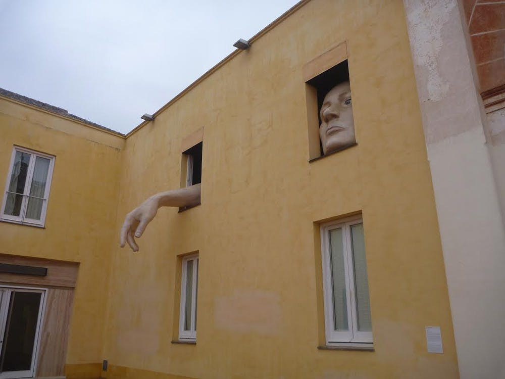 "Alice," an installation at the Centro Andaluz de Arte Contemporáneo, shows a giant face and arm protruding from the windows. Columnist Lauren Saxe visited the museum during her first weekend in Seville, Spain.