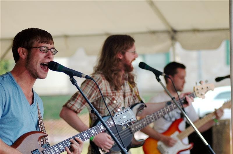 Alexander the Great guitarist Bryant Fox, left, performs during Timmypalooza Sunday in Dunn Meadow. The charity festival featured several area bands and benefited the Timmy Foundation.