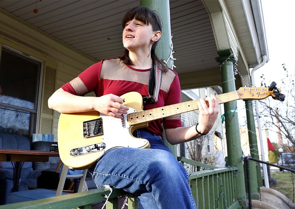 Hannah Groves sings "Palm Tree Dream" Wednesday in front of "Middle Earth," a Bloomington co-operatvie living place. Groves is a leader singer and a guitarist of the band "Local Surfing." The band was organized in last spring and released a second album three days ago. 
