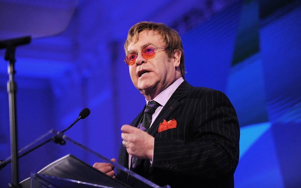 <p>Elton John receives a Lifetime Achievement Award from David Rockefeller Jr. for his advocacy on behalf of people with HIV or AIDS on Oct. 30, 2013, at the Red Cross headquarters in Washington, D.C. </p>