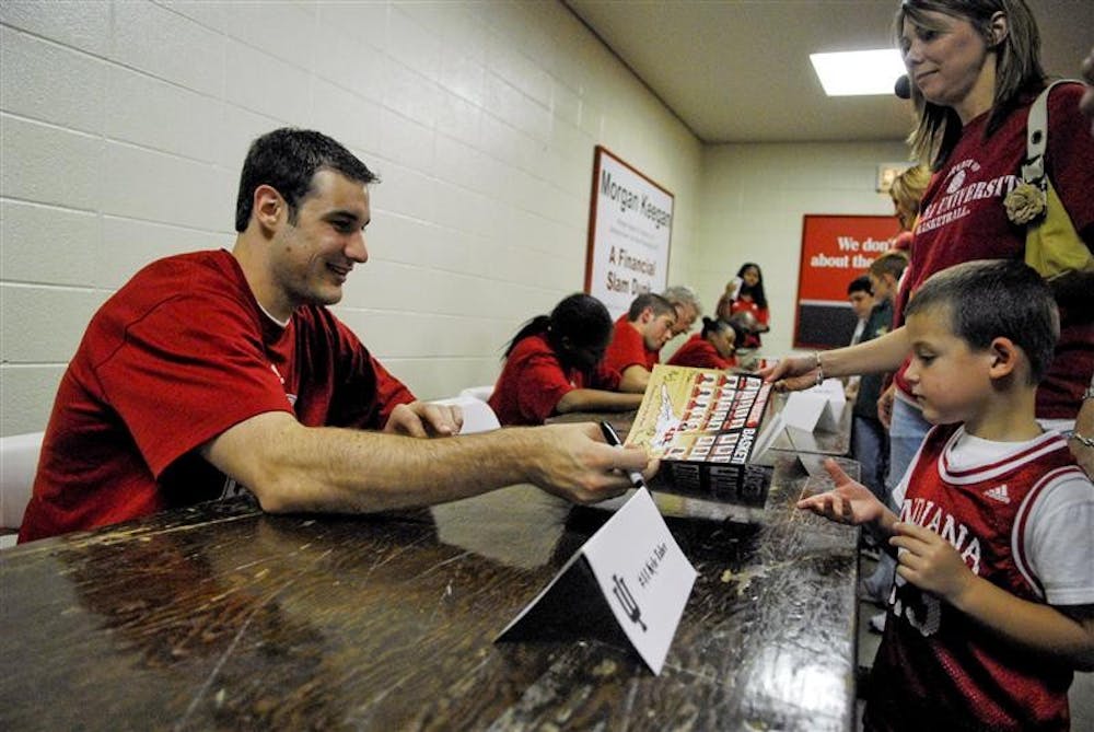 IU's Kyle Taber signs an autograph for a young fan during Hoosier Hysteria on Friday at Assembly Hall.