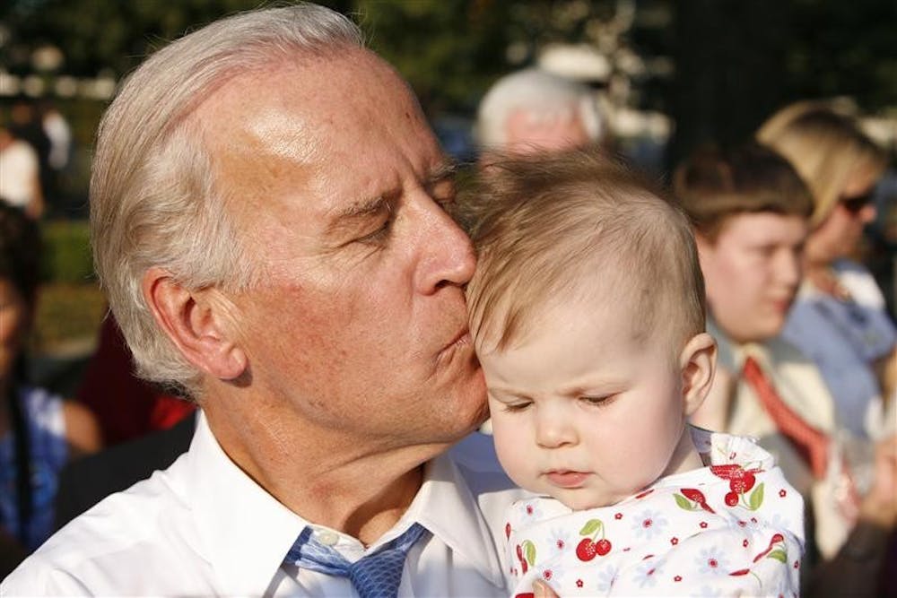 Democratic vice-presidential candidate Sen. Joe Biden kisses the head of a baby following his rally Wednesday afternoon at Walder Park in Jeffersonville, Ind.
