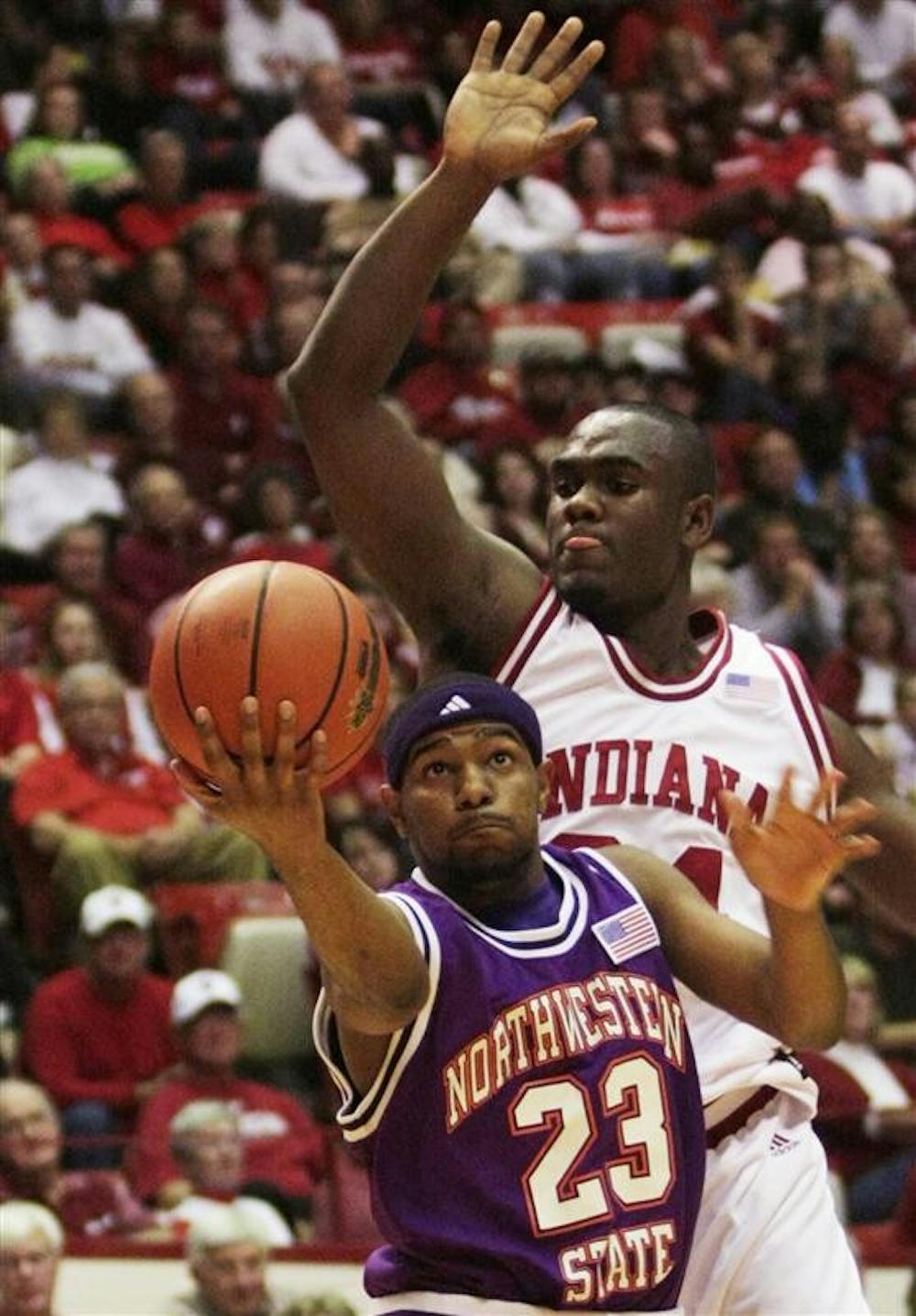 Freshman guard Malik Story attempts to block a shot from Northwestern State's Keithan Hanckock during IU's 83-65 win Saturday at Assembly Hall. IU will face IU-Purdue University Indianapolis at 7 p.m. today at Assembly Hall.